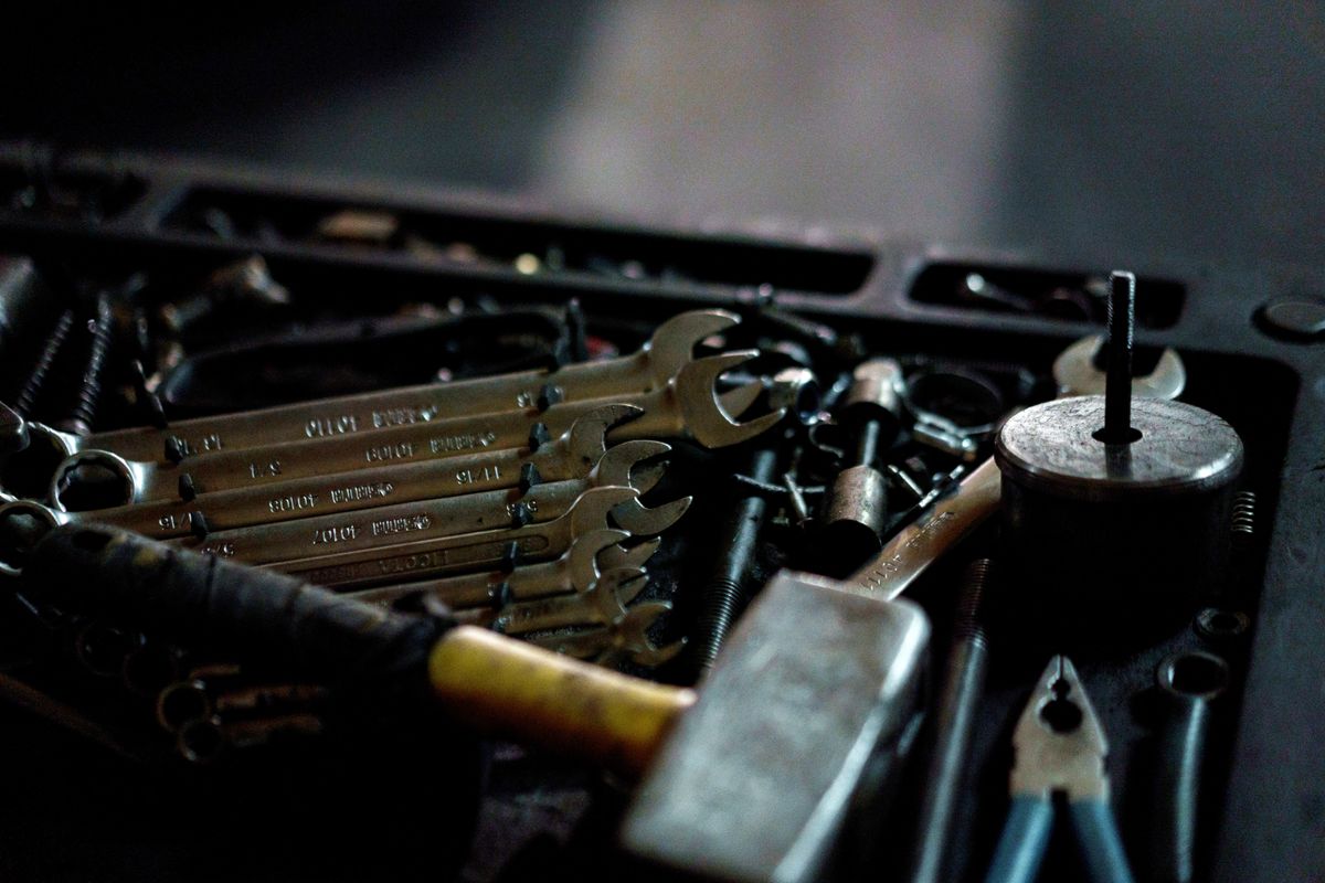 A toolbox of wrenches and plumbing tools