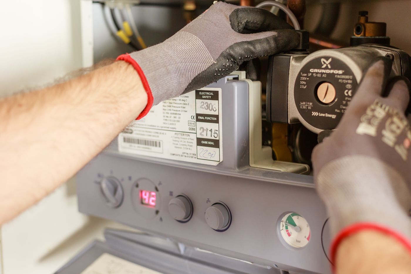 A technician servicing a hot water unit